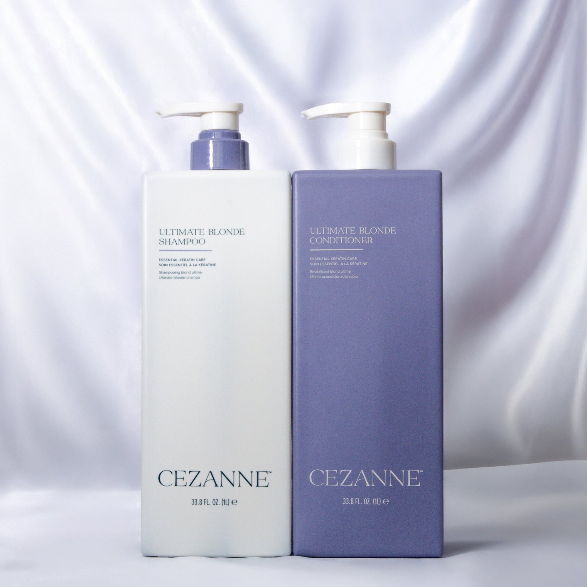 Cezanne Ultimate Blonde shampoo and conditioner bottles on a silk background