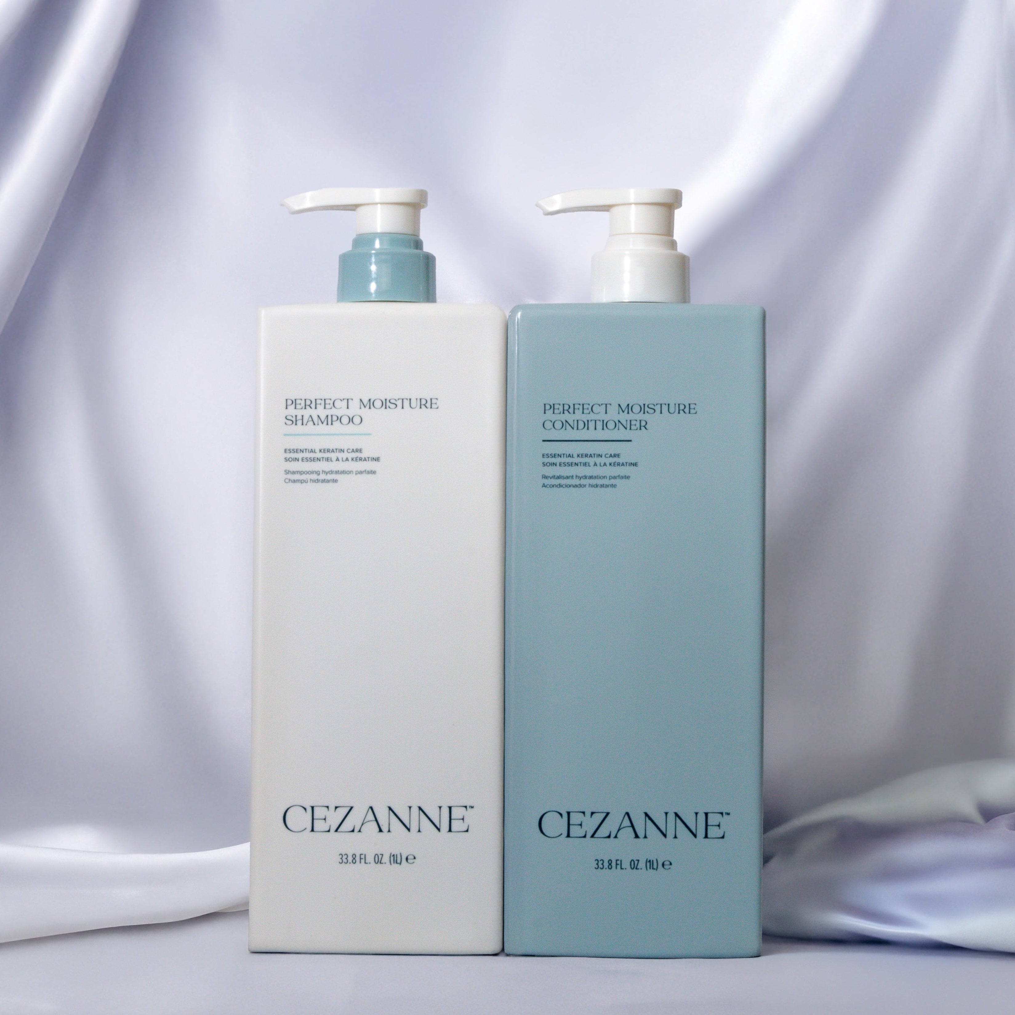CEZANNE Perfect Moisture shampoo and conditioner bottles on a silk background