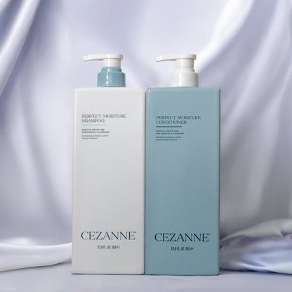 CEZANNE Perfect Moisture shampoo and conditioner bottles on a silk background